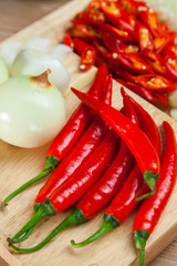 Red hot chili pepper with Onions on the Chopping Block