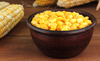 Canned corn  in a bowl on old wooden table