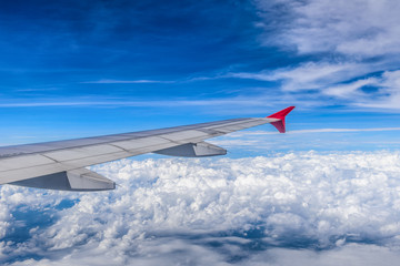 Wing of airplane with blue sky view.