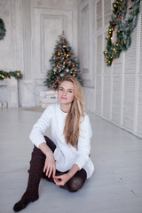 Beautiful girl on the background of a Christmas tree