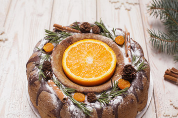 Traditional homemade christmas cake holiday dessert with orange on wooden background with festive...