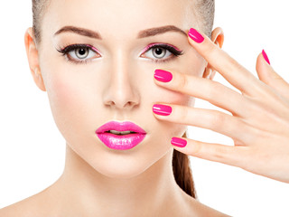 Fototapeta premium eautiful woman face with pink makeup of eyes and nails.