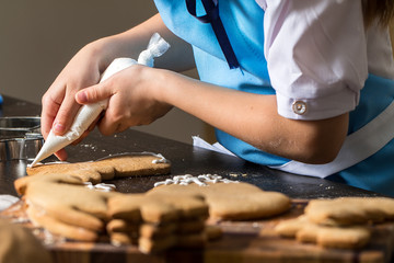 kids hand decorating cookies with sugar.