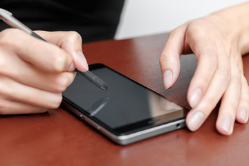 The girl behind the Desk with a smartphone and stylus.