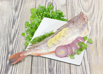 Uncooked red cod, lemon, red onion and herbs