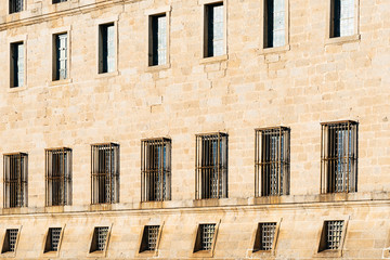 Fototapeta na wymiar Old building stone facade with multiple windows