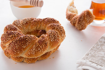 Turkish bagel, simit, and traditional tea on a table.