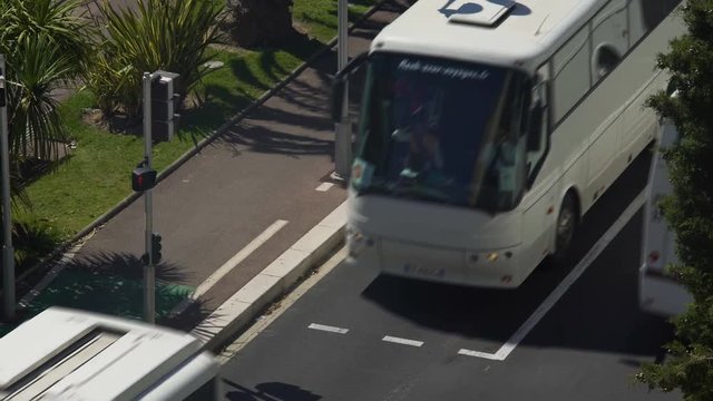 Narrow road with airport shuttles on their route, running from and to terminals