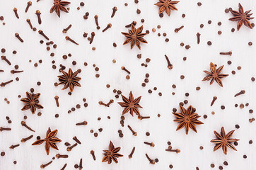 Spices collection pattern on white soft wood board.