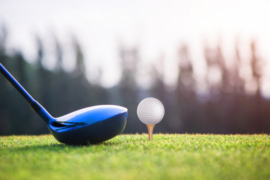 wood driver in proper address of the woman golf player on tee off at golf club, ready to hit and impact away to the fairway ahead