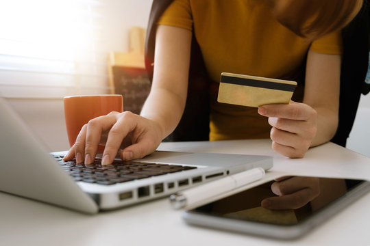 Business woman hands using laptop and holding credit card with digital layer effect diagram as Online shopping concept
