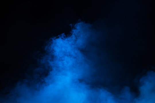 Blue theatrical smoke on stage during a performance or show.