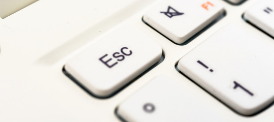 Macro recording of the escape character on a white laptop keyboard