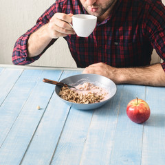 Healthy food. Man eating healthy breakfast in kitchen at home