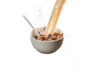 A bowl of chocolate Corn flakes with milk splash isolated over white background