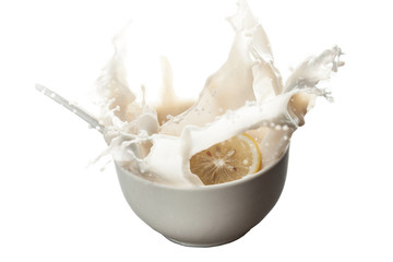 Pouring milk into bowl with fruits and splashes isolated with white background