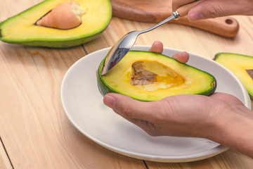 Healthy food concept. Eating fresh organic avocado