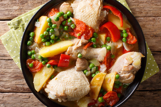 Filipino Afritada: slices of chicken with vegetables close-up in a bowl. horizontal top view
