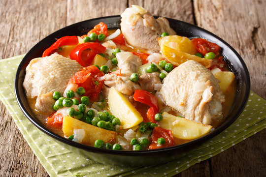 Chicken meat stewed with vegetables and spices close-up in a bowl. horizontal