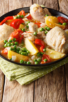 Philippine Afritada: chicken stew with vegetables close-up in a bowl. vertical