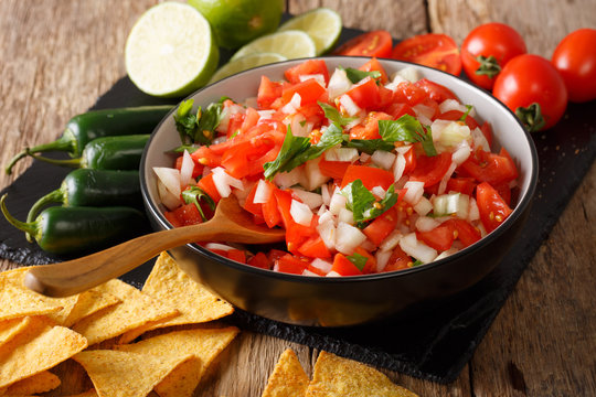 Mexican pico de gallo from tomatoes, onions, cilantro and jalapeno pepper close-up. Horizontal