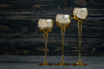 Yellow Candle Holders Like Wineglasses on Blue Background.