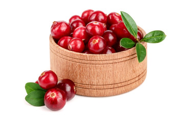 Cranberry with leaf in wooden bowl isolated on white background closeup