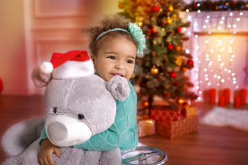 Little mixed African Girl at Home with Christmas Interior