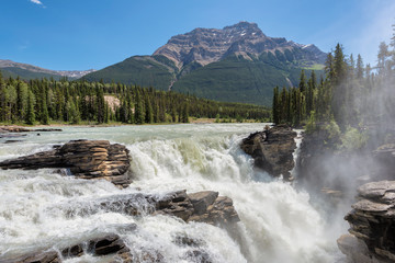 Fototapeta na wymiar Athabasca Falls and pyramidal mountain in Jasper National Park, Alberta, Canada.