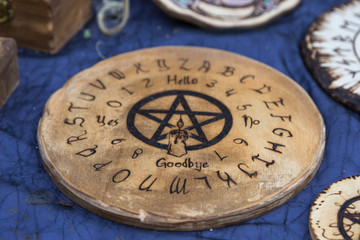 Fototapeta na wymiar Wooden Round Board Ouija: Communication with Spirits