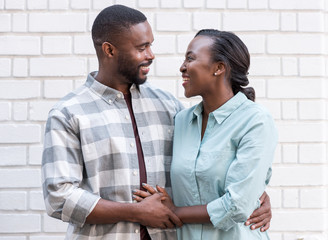 Affectionate young African couple standing together in the city