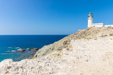 Fototapeta na wymiar A white lighthouse in The Prasonisi National Park on the southern end of Rhodes in Greece 