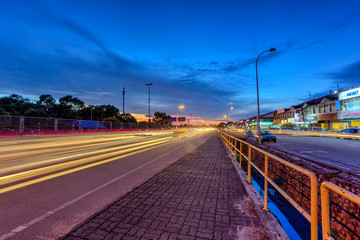 Fototapeta na wymiar 1 Dec 2017 Taman Perlin, Johor Bahru, Malaysia :Light trails at blue hour on road of traffic lights with long exposure photography