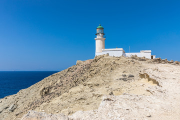 Fototapeta na wymiar A white lighthouse in The Prasonisi National Park on the southern end of Rhodes in Greece 