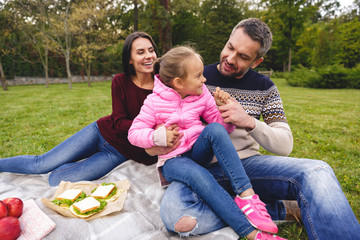 Happy young family having picnic