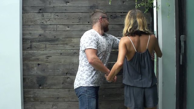 Happy couple walking out through door, super slow motion 240fps
