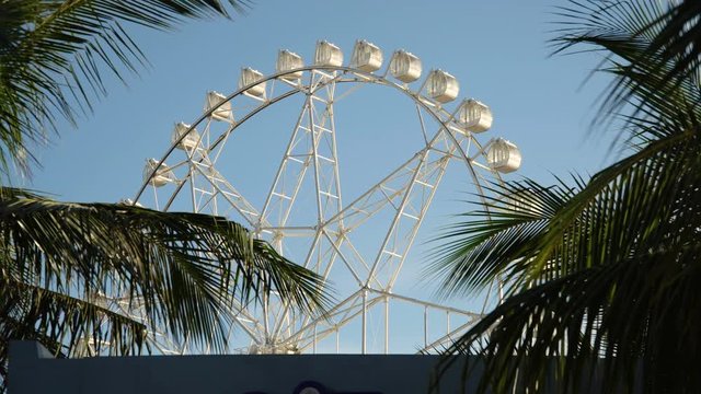 Ferris wheel in Manila, Mall of Asia. Ferris wheel against a blue sky. 4K video, Philippines.