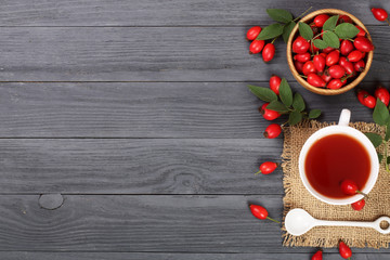 tea with rose hips and honey on a black wooden background with copy space for your text. Top view