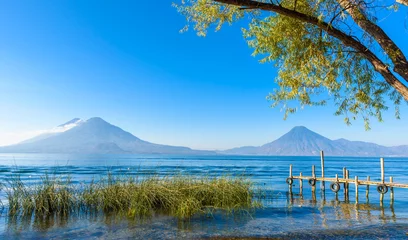 Crédence en verre imprimé Jetée Jetée en bois au lac Atitlan sur la rive à Panajachel, Guatemala. Avec de beaux paysages paysagers des volcans Toliman, Atitlan et San Pedro en arrière-plan.