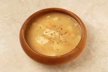 Potato soup in a wooden bowl 