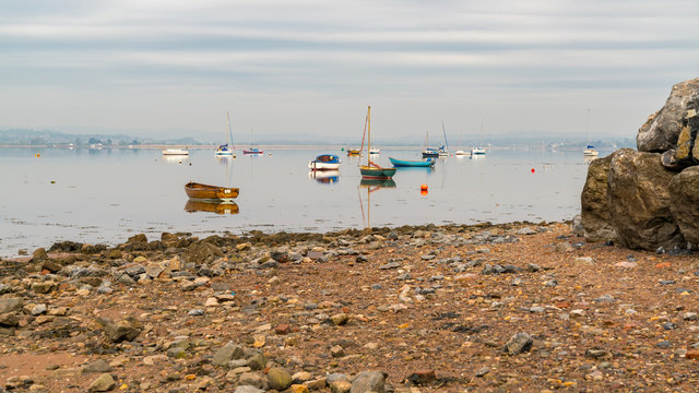Boats on the shore of the River Exe in Lympstone, Devon, UK