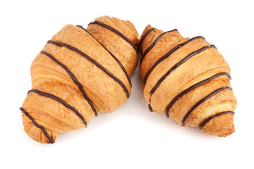 croissant decorated with chocolate sauce isolated on white background, top view