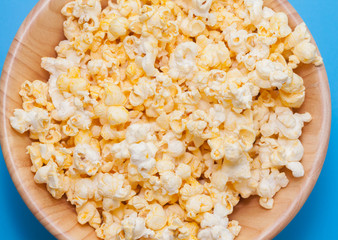 popcorn in wooden on blue background