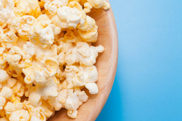 popcorn in wooden on blue background