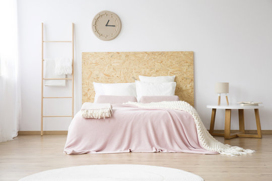 Pink bedsheets on king-size bed