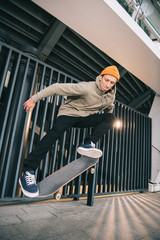 professional skateboarder performing jump trick in urban location