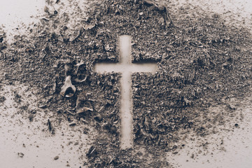 top view of cross shape from ash on white table - obrazy, fototapety, plakaty