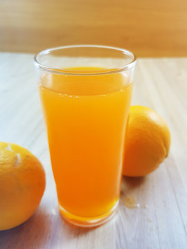 Select focus, Glass of fresh orange juice on the table background.