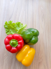 Fresh and sweet bell pepper Green, Yellow, Red  on wood table background.