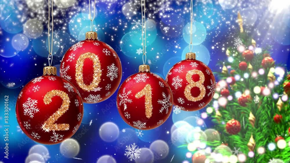 Poster red balls with numbers 2018 hanging on the background of a blue bokeh and a rotating christmas tree 